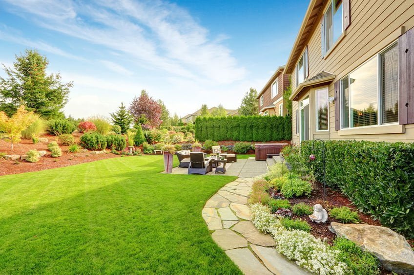 Impressive backyard landscape design with cozy patio area